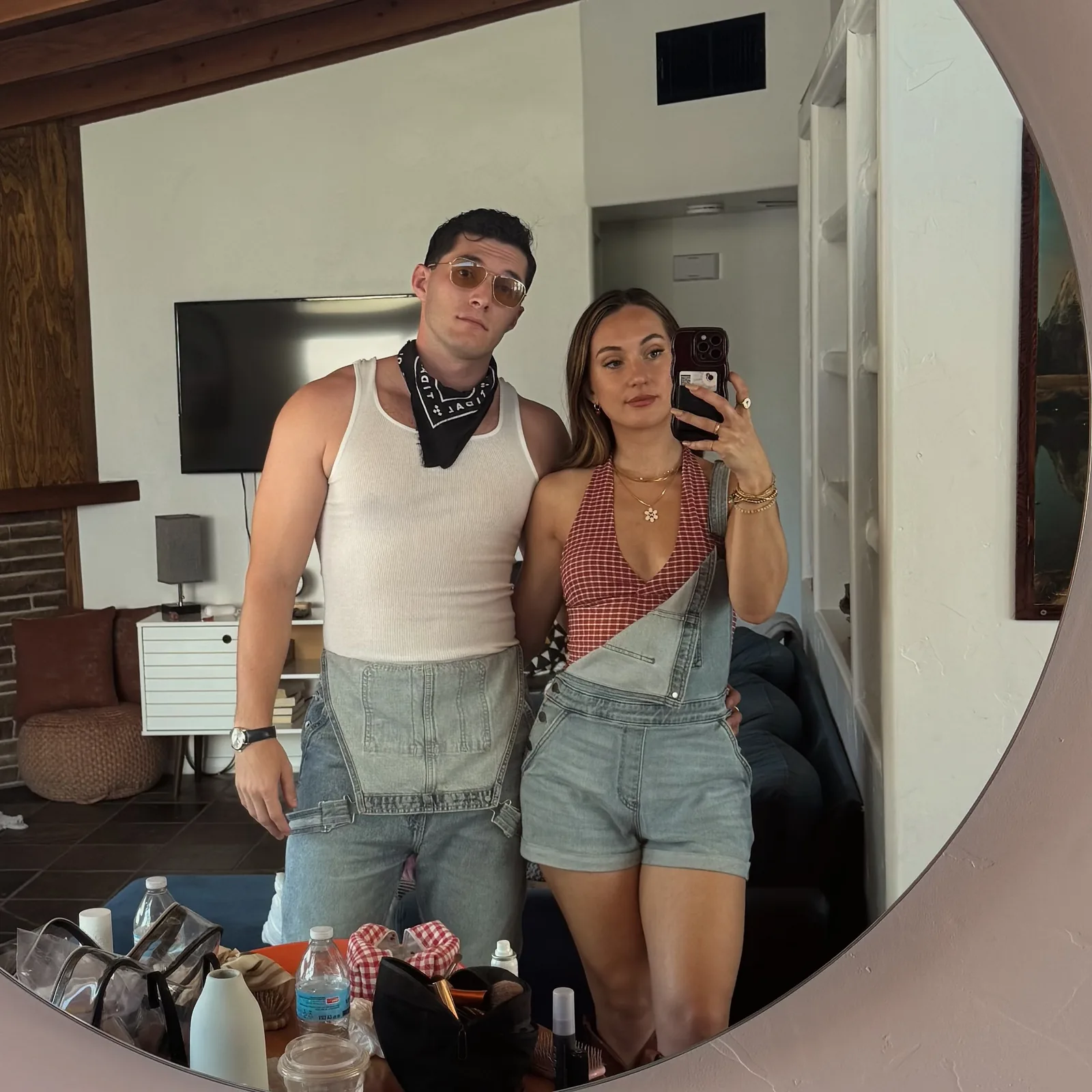 Meaghan and Roman in matching overalls, a mirror selfie