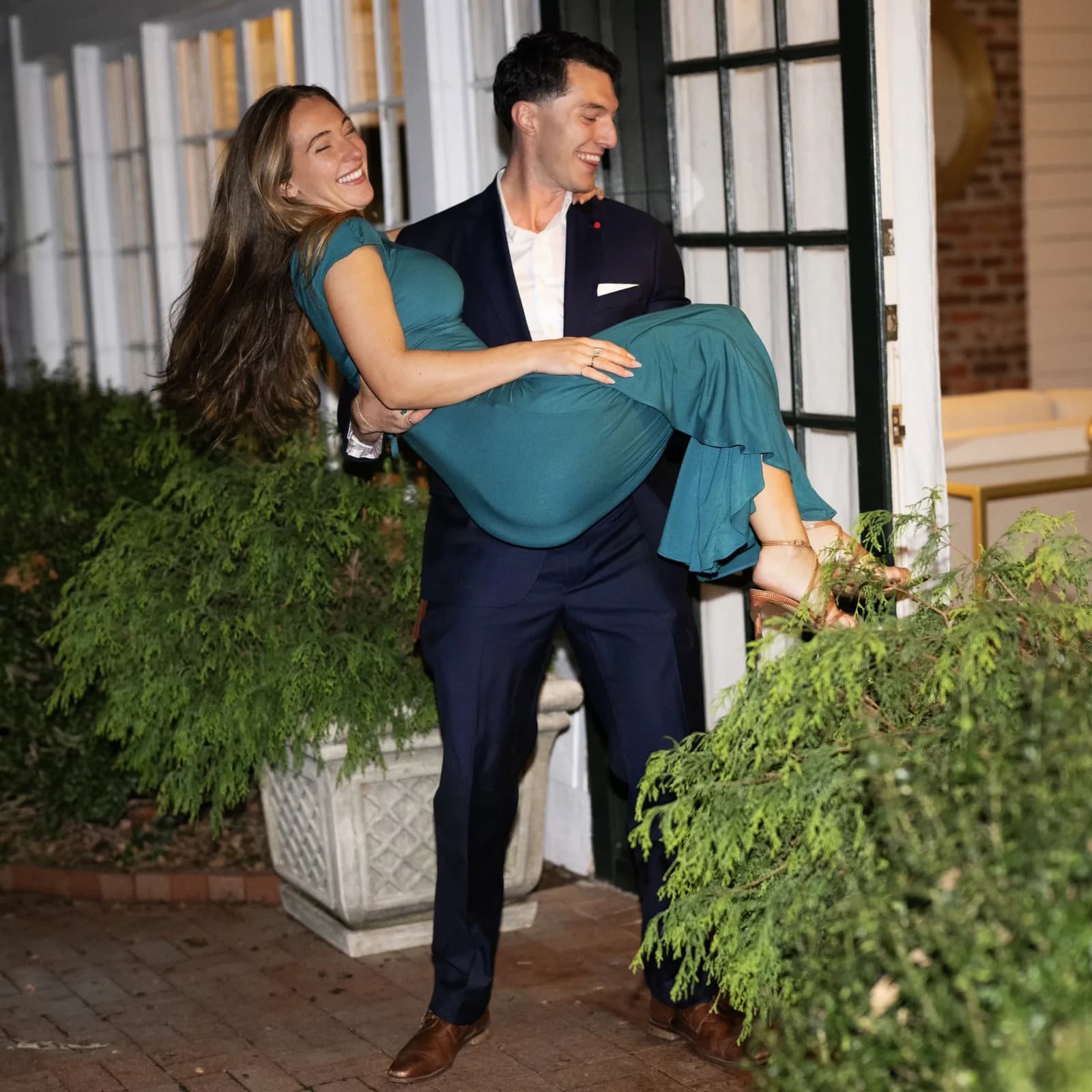 Roman carrying Meaghan, both laughing